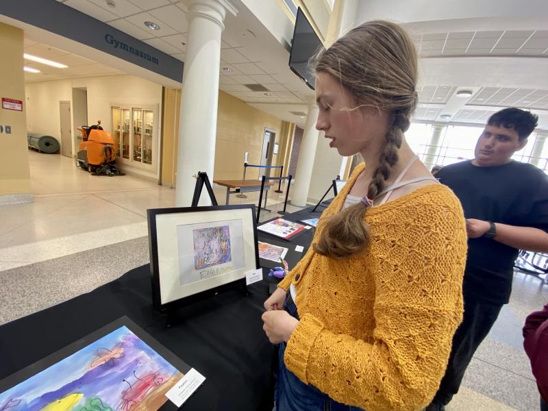 Student Elle Nauman takes a look at the artwork on display.